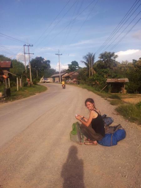 Sydney waiting for a truck or car in Pakmong, Laos...