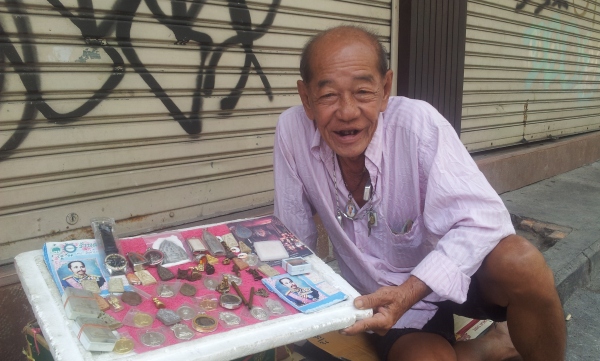 This man sits on the street all day with his little display of trinkets to sell. He asks me if I want to hire a man for the night!!! "You only live once!" he says!